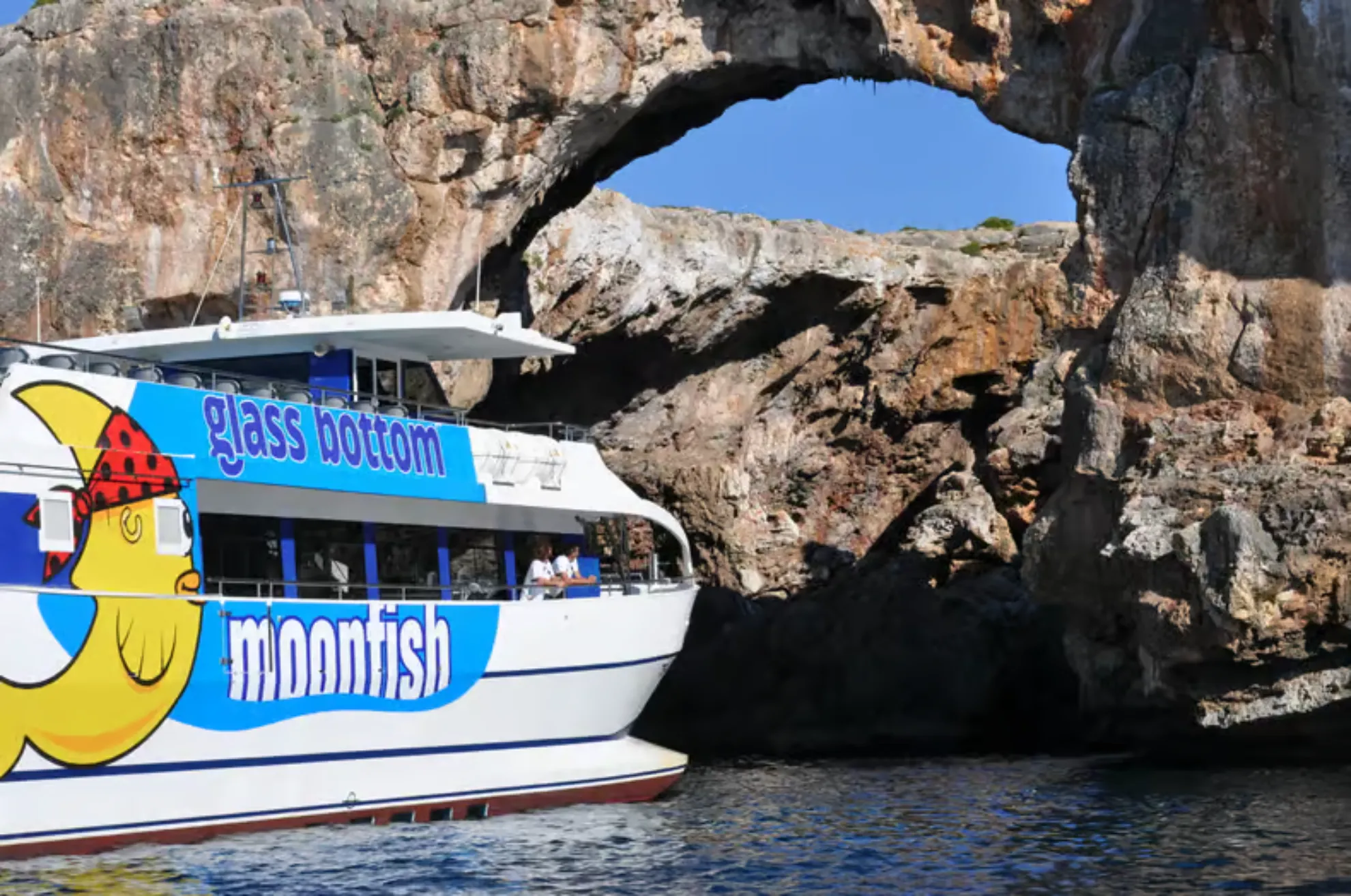 Glass-bottom catamaran sailing through the coves of Manacor
